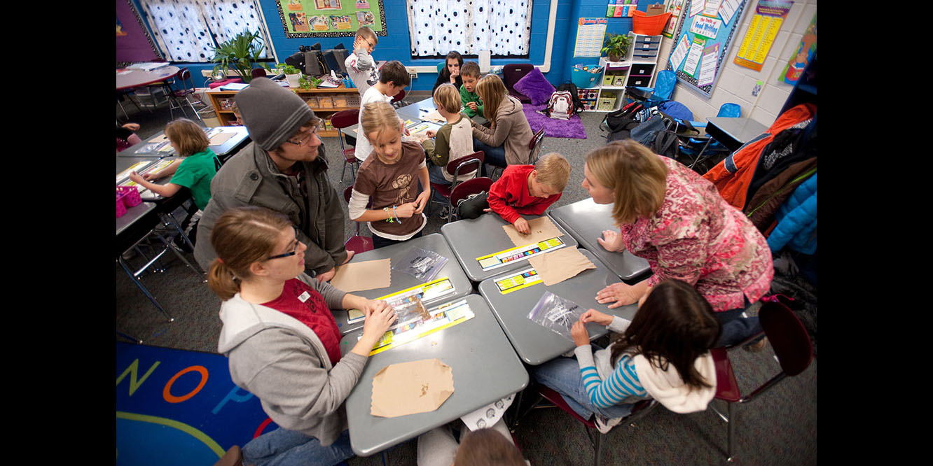 photo - Hesston College Environmental Biology students work with Hesston Elementary third graders.