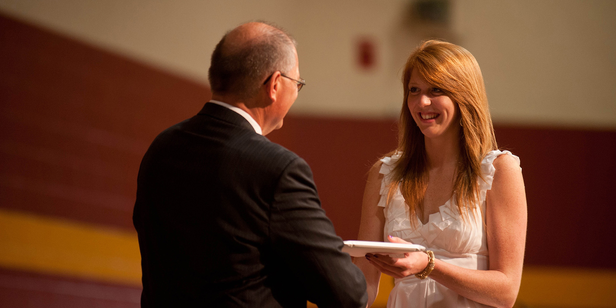photo - Kate Steury (New Paris, Ind.) receives her Hesston College diploma from President Howard Keim. Steury was one of 167 graduates of Hesston’s 102nd graduating class.