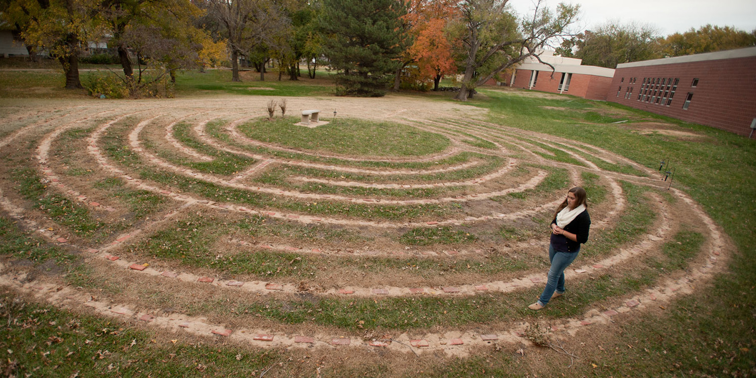 photo - Sophomore Maria Diener walks the college's new prayer labyrinth which was completed this fall.