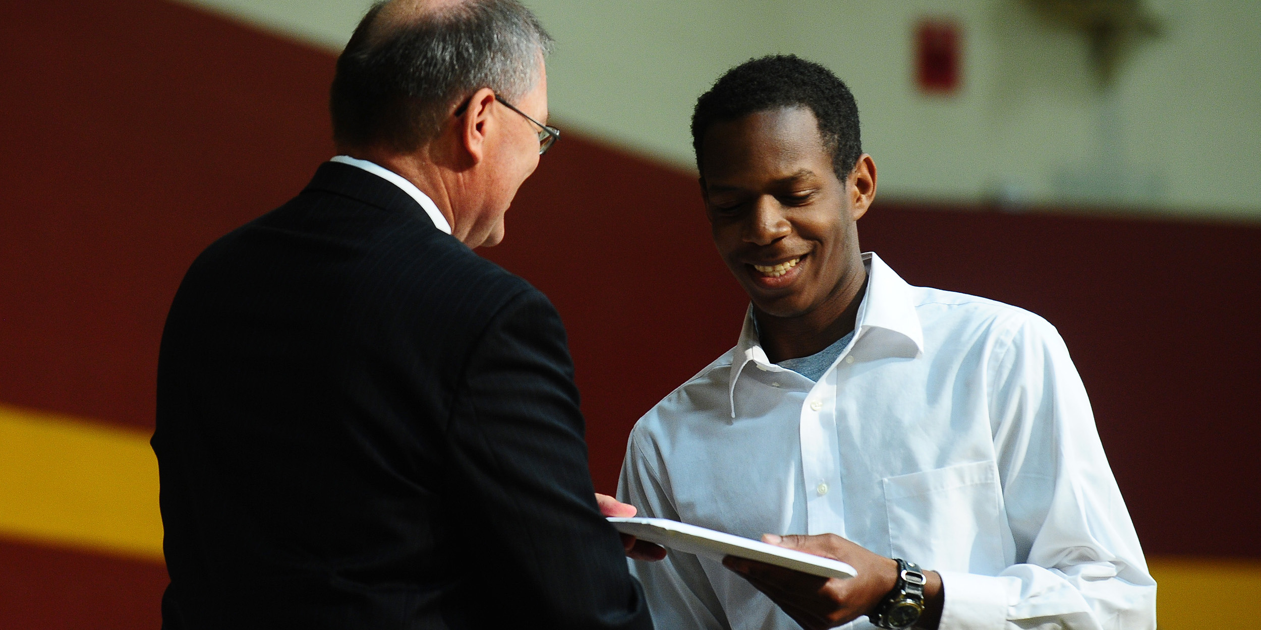 photo - Curtis Denlinger of Perkasie, Pa., receives his Hesston College diploma from President Howard Keim. Denlinger was one of 139 students to receive a diploma.