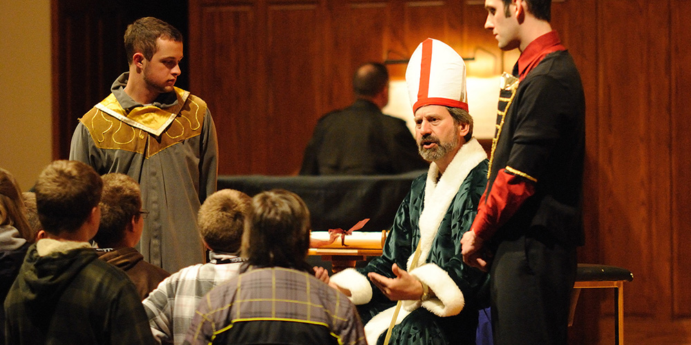 photo - Faculty member John Sharp plays a leader of the state church during the Anabaptist Game, along with students Joel Murray of and Tyler Jones.