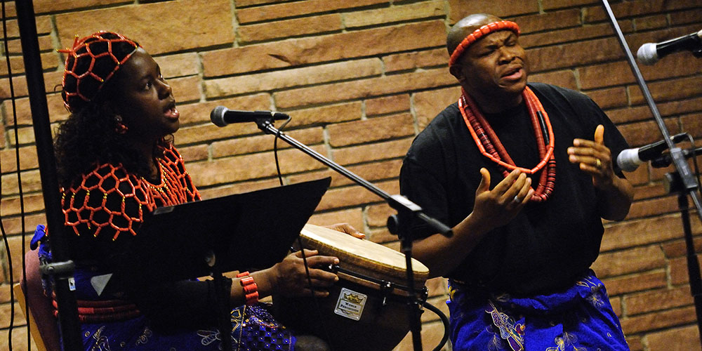 photo - Hesston College Pastoral Ministries student CJ Chukwukelu (right) and his wife Ude perform at an on-campus coffeehouse Jan. 21. The coffeehouse was one of several events at Hesston College Jan. 17 to 21 in honor of Martin Luther King Jr. Week. Other events included conversations with nationally-recognized human rights and environmental activist Rosina Philipe from Grand Bayou, La., a gospel concert by Voices of Joy choir from Dell Rose Methodist Church in Wichita, Kan., and presentations on various aspects of Dr. King’s life and work by guest speakers and faculty members.