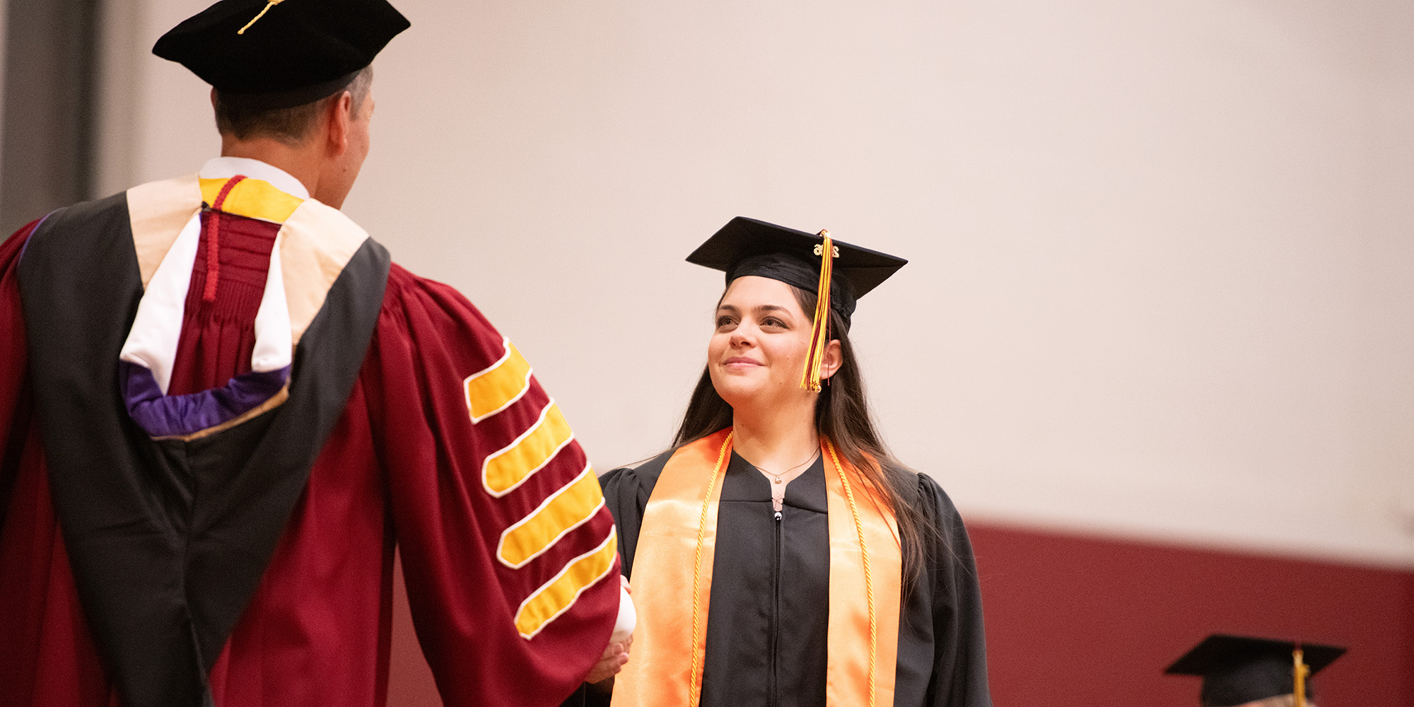 photo - President Mark Landes congratulates Bachelor of Science in engineering degree recipient Tana Hayworth of Lincoln, Kan., during Saturday’s commencement ceremony.