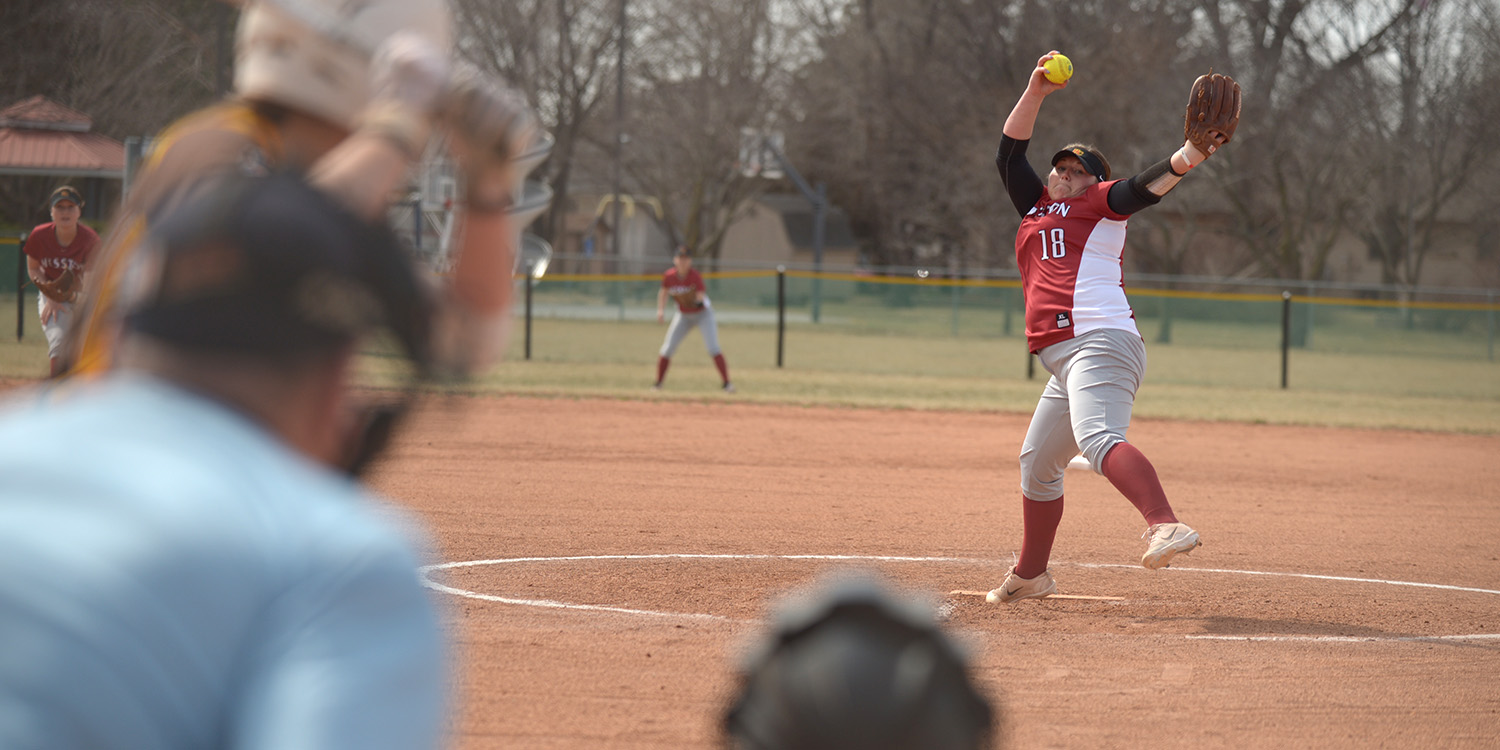 action photo - Asley Yasin pitching for the Hesston College Larks softball team
