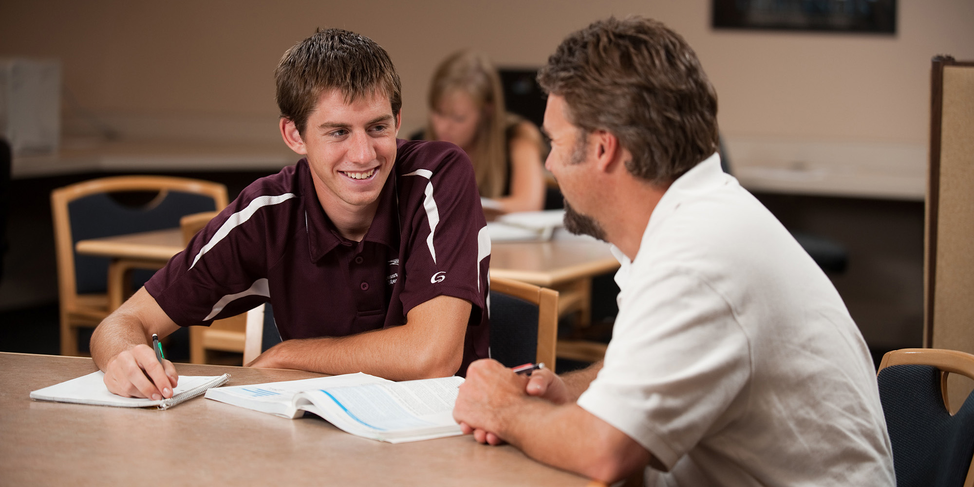 photo - Elliot Wilder ’11, Hesston, Kan., gets help from business faculty David LeVan in the ACCESS lab.