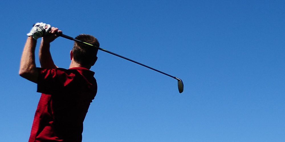 photo of a golfer hitting a drive