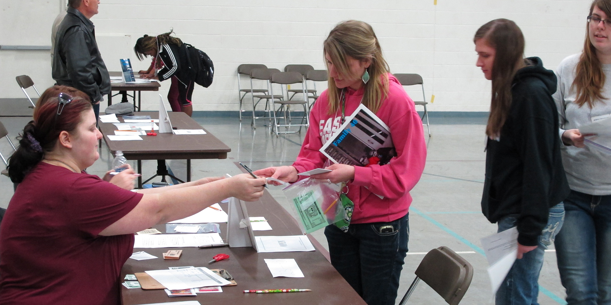 photo - Sophomore Andrea Kelley (Archbold, Ohio) makes a transaction with a Circles of Hope Volunteer during the poverty simulation.