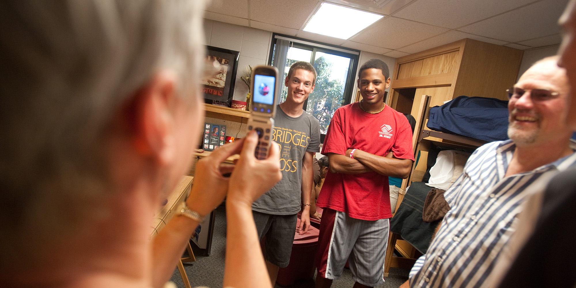 photo - Freshmen roommates David Rudy (Manheim, Pa.) and Michel Anderson (Wichita, Kan.) pose for Rudy’s mother, Carolyn, as they moved in to Kauffman Court at the beginning of the year.