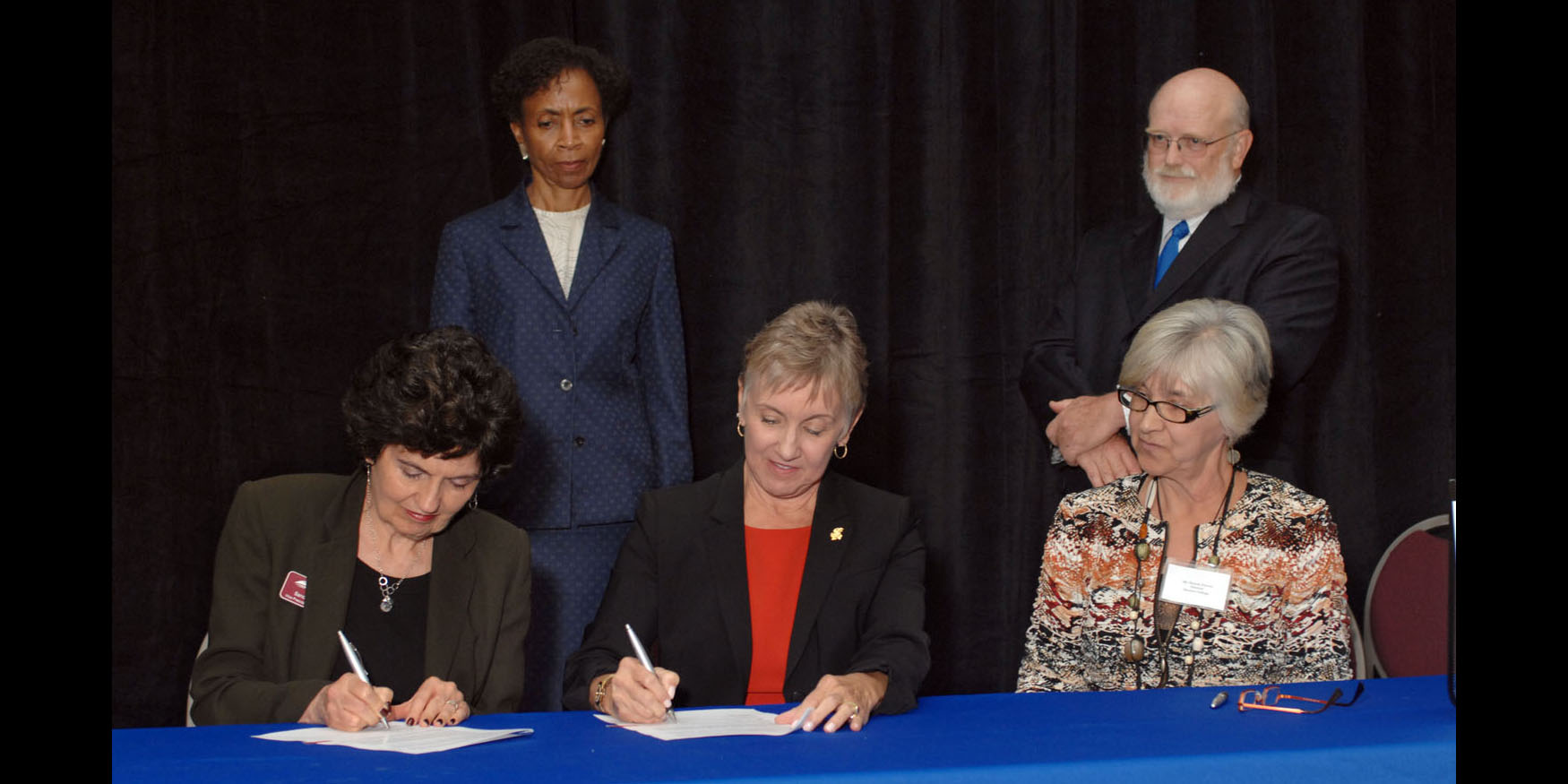 photo - Dr. Sandra Zerger, Vice President of Academics at Hesston College, and Dean of the University of Kansas School of Nursing, Karen Miller, RN, Ph.D., FAAN, sign an articulation agreement for nurses.