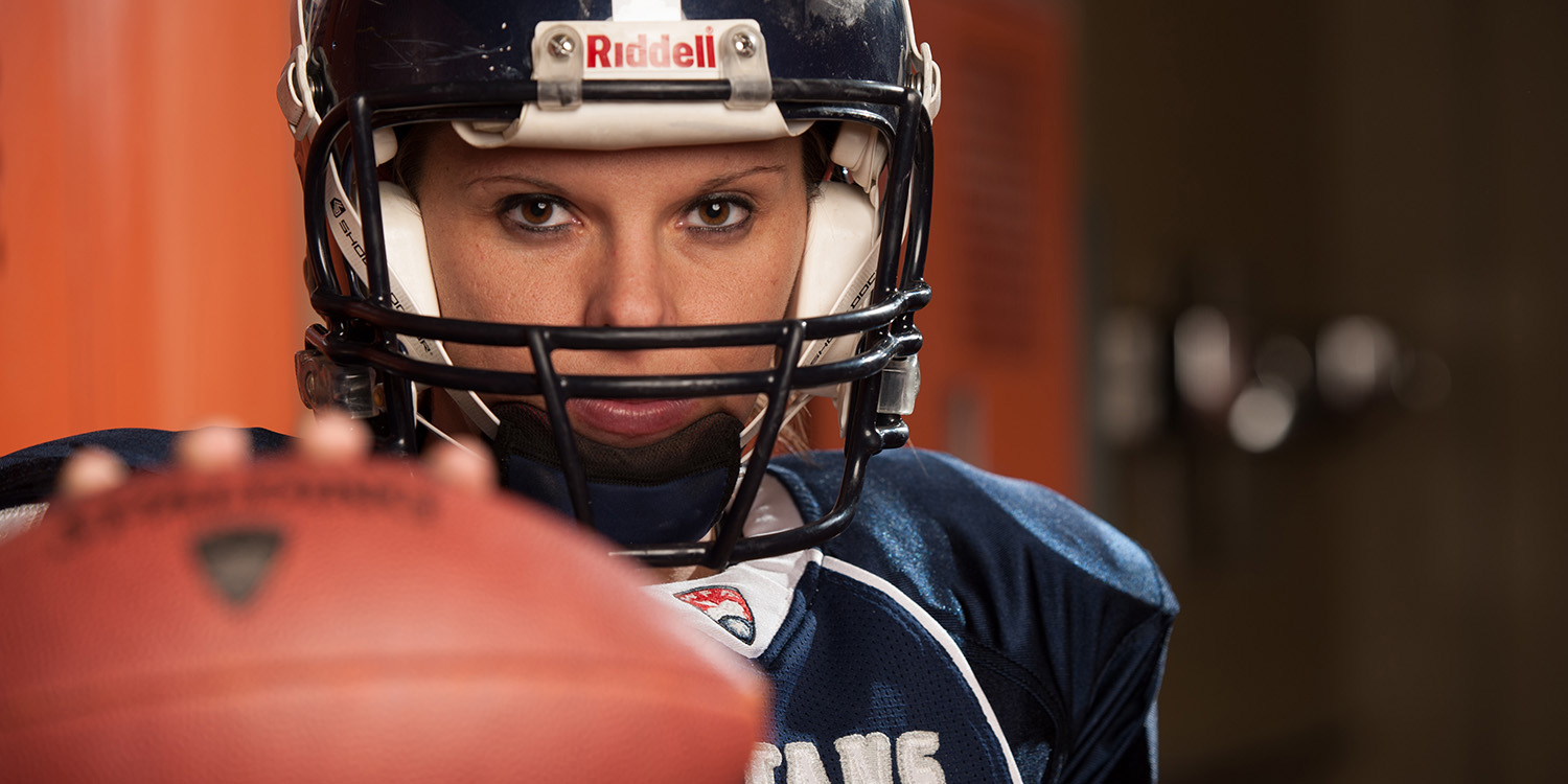 photo - Katie Sowers in football uniform. Katie SowersSowers, a 2006 Hesston College graduate, is the quarterback for the Kansas City Titans, one of 45 teams in the Women’s Football Alliance (WFA). In 2013 she played defensive back for the United States IFAF Women’s World Championship (WWC) team that brought home gold from Finland. She was also selected for the WWC all-tournament team and was named game MVP in the semi-final win over Germany after snagging five interceptions and returning three for touchdowns.