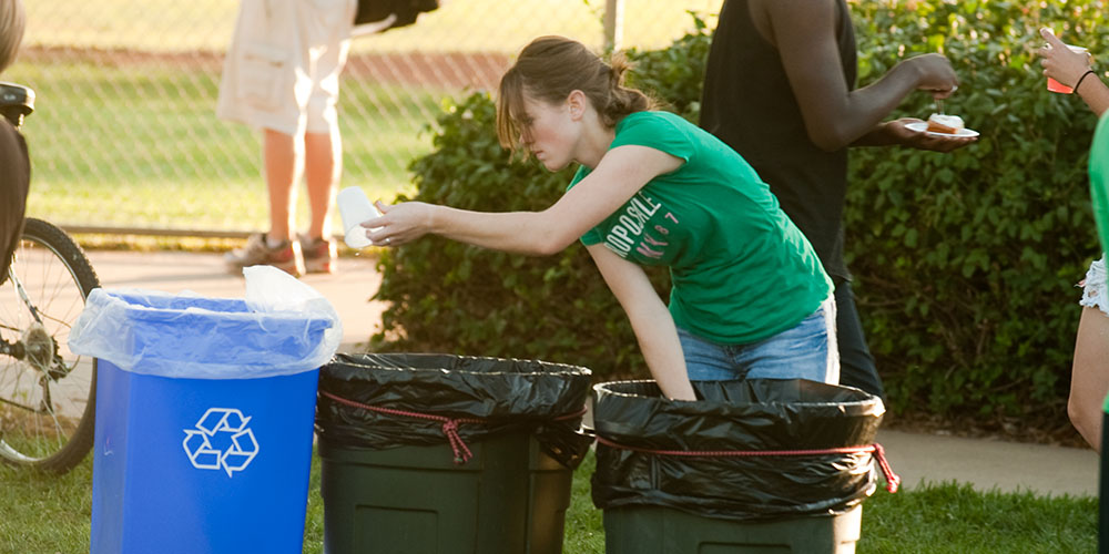 photo - Hesston College sophomore Leah Mueller of Halstead, Kan., separates recyclables from trash during the college’s September 2011 homecoming celebration.