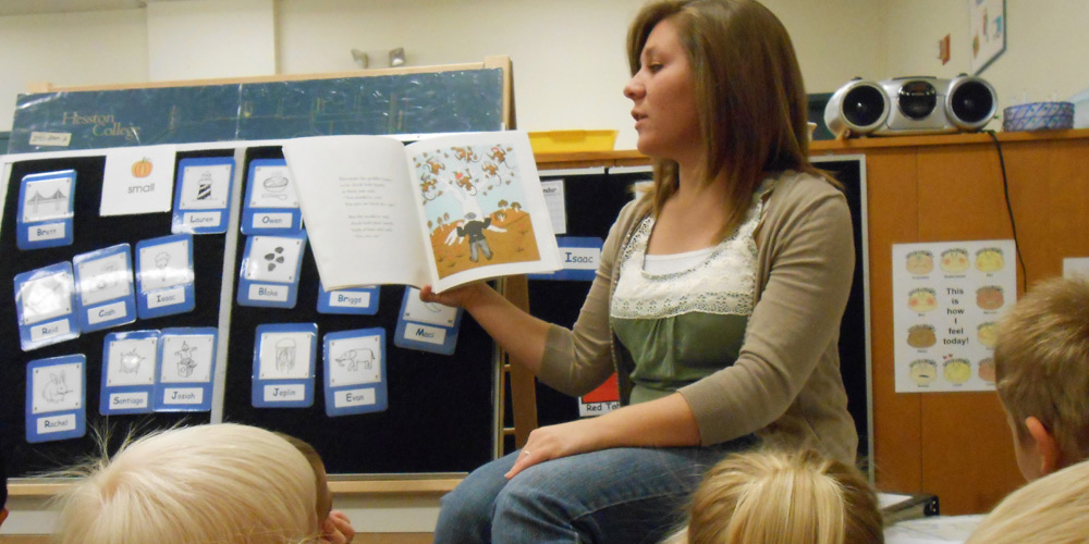 photo - HC student Morgan Martin reads to students at Hesston College Preschool