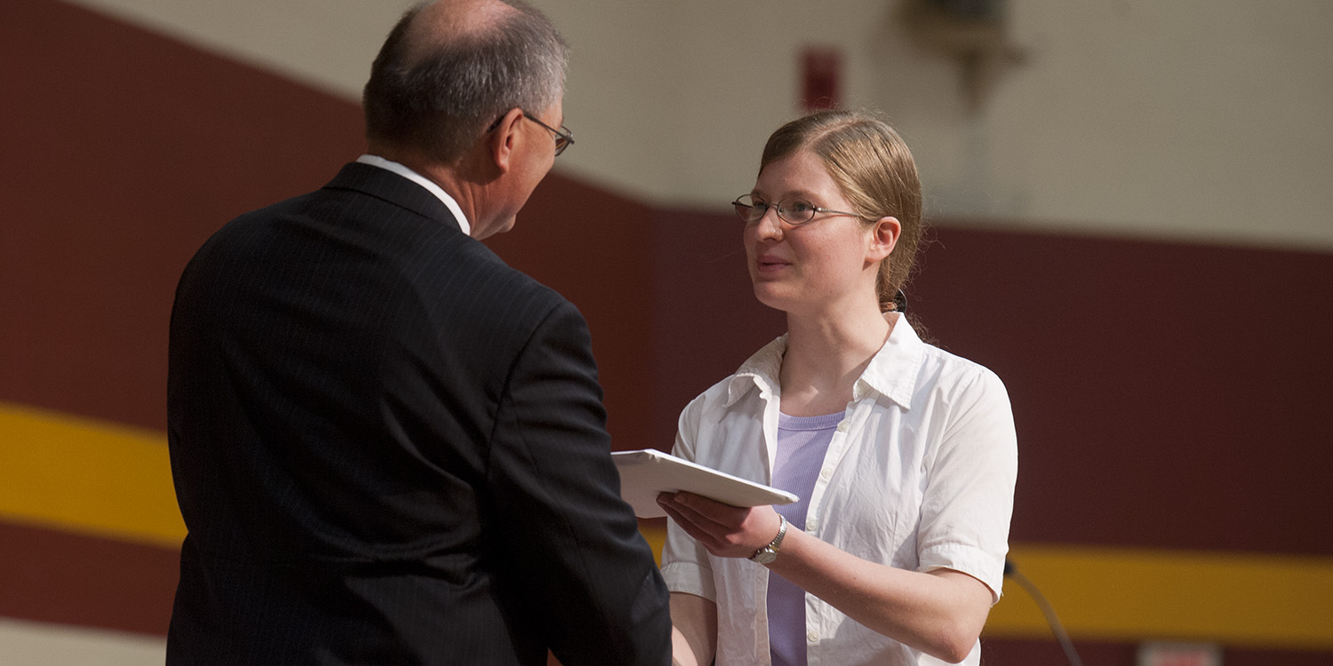 photo - Sheralynn Neff receives her Hesston College diploma from President Howard Keim during Commencement in May 2011.