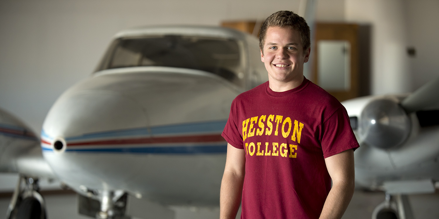 portrait of Jordan Stoltzfus with an aircraft in the background
