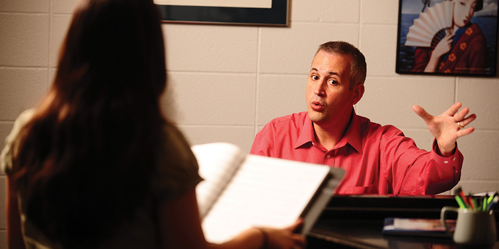 photo - Matt Schloneger works with a Hesston Colleg student during a private voice lesson