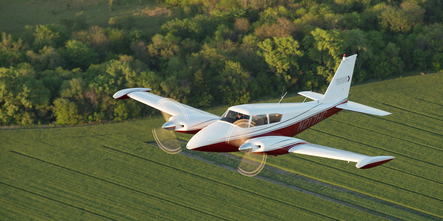 Air-to-air photo of a Piper Twin Comanche aircraft in flight