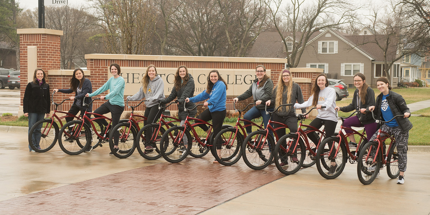 Senior nursing students in Population-Based Nursing course pose with the bikes they assembled for a campus bike share program.
