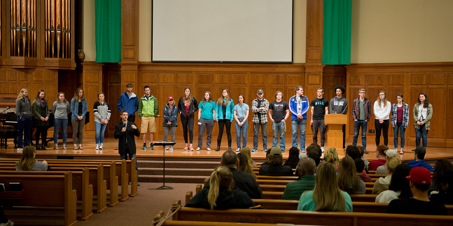 Campus Pastor Todd Lehman commissions student and staff volunteers for service projects in the coming summer and fall
