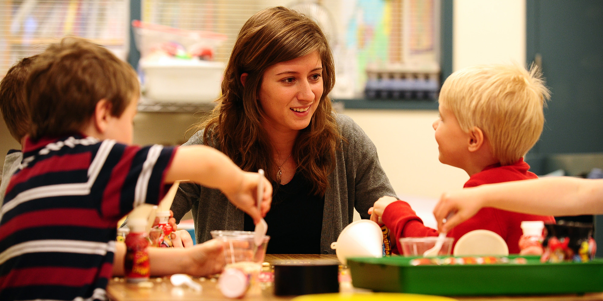 photo - Hesston College sophomore Deb Yoder works with preschoolers in the Hesston College Lab Preschool. The preschool serves as a learning environment for both preschool children and for the college students who work with them.