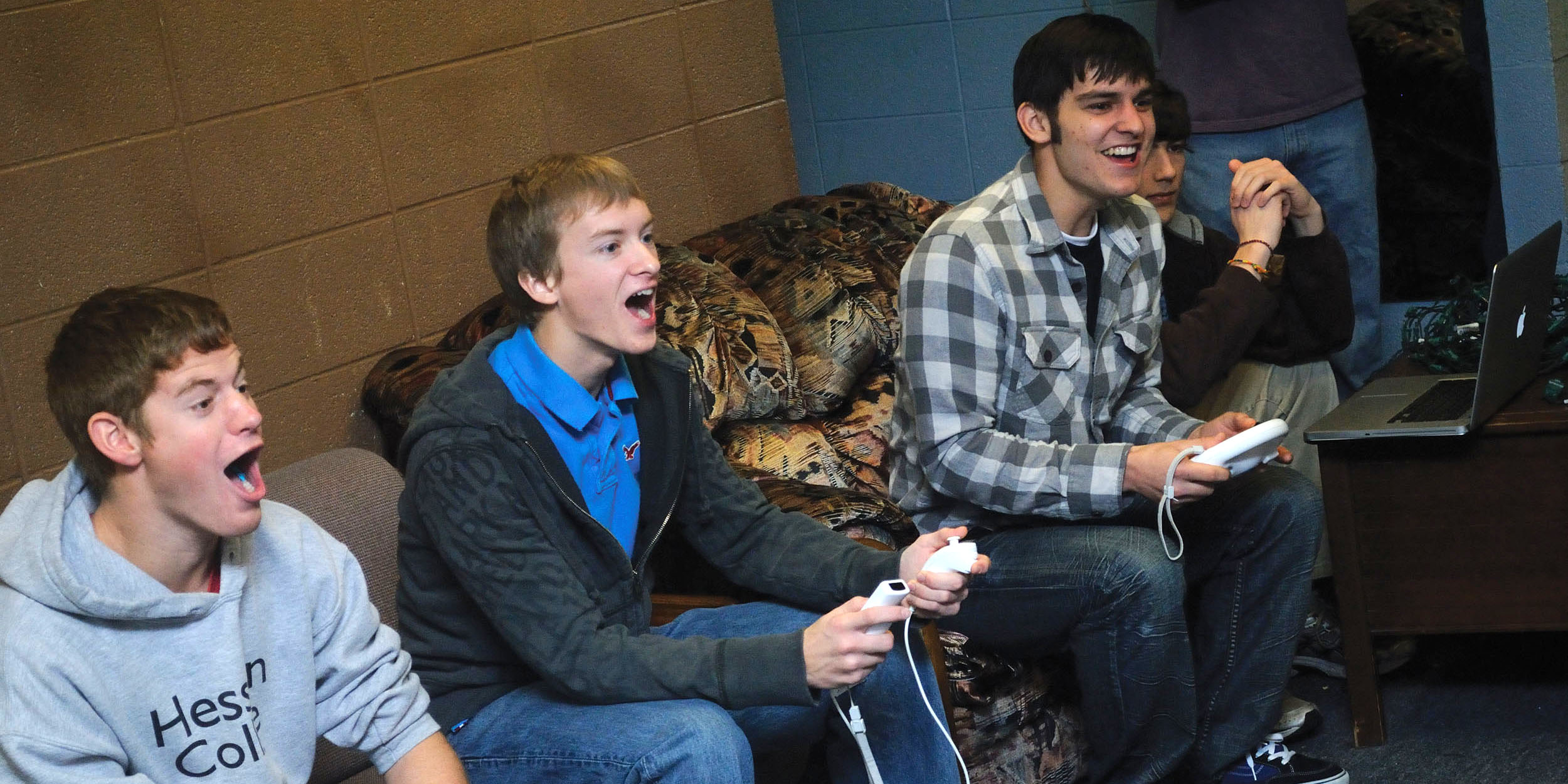 photo - From left, freshman Kenny Graber of Stryker, Ohio, Bradley Sandlin of Valley Center, Kan., Stephen Quenzer of Visalia, Calif., and Harrison Beachey of New Paris, Ind., play a video game in their Erb west lounge.
