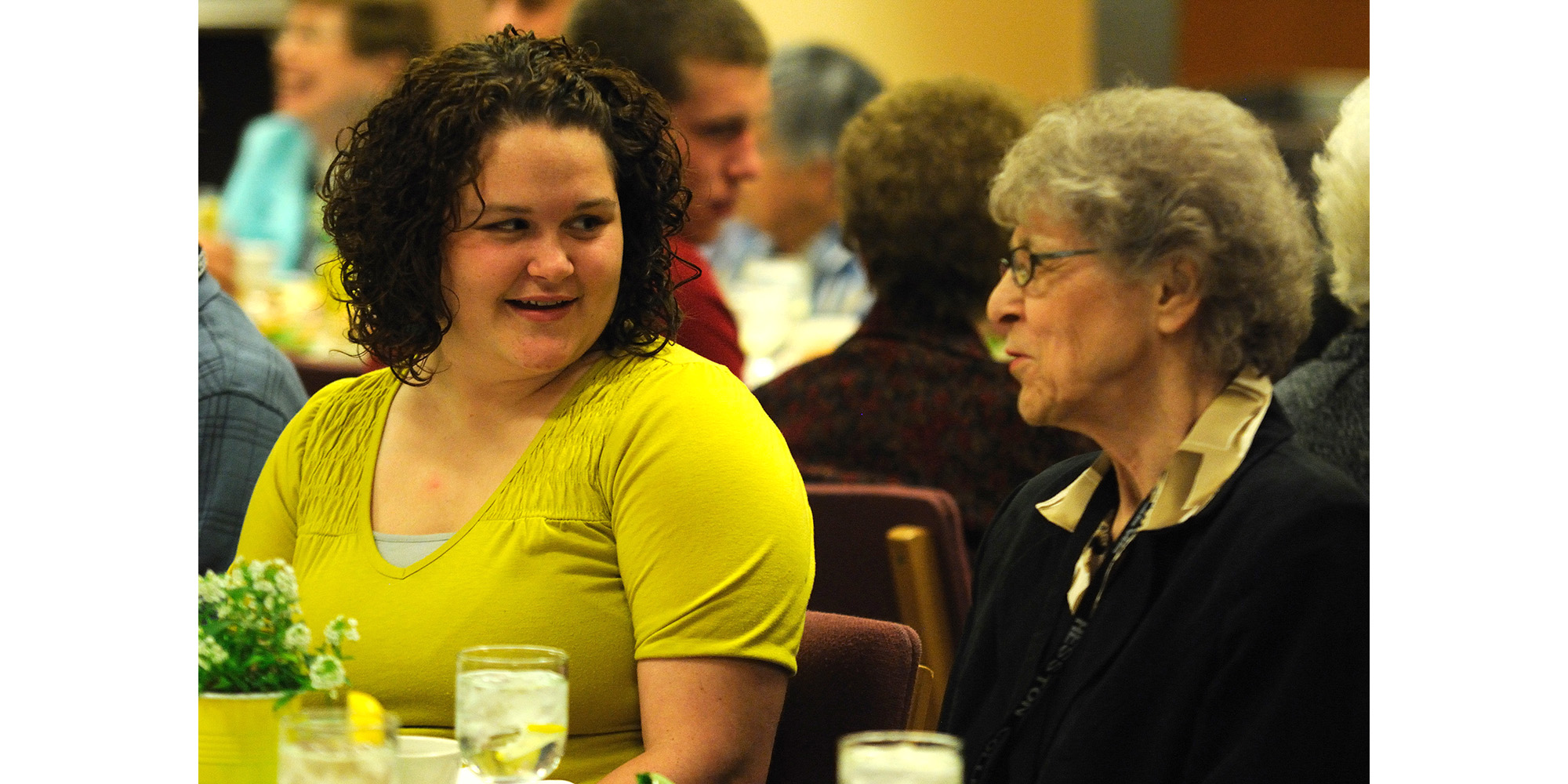 photo - Hesston College freshman Courtney Mast talks with her grandmother Mari An Nyce, both of Weatherford, Okla., at the banquet in celebration of Grandparent Days March 24.