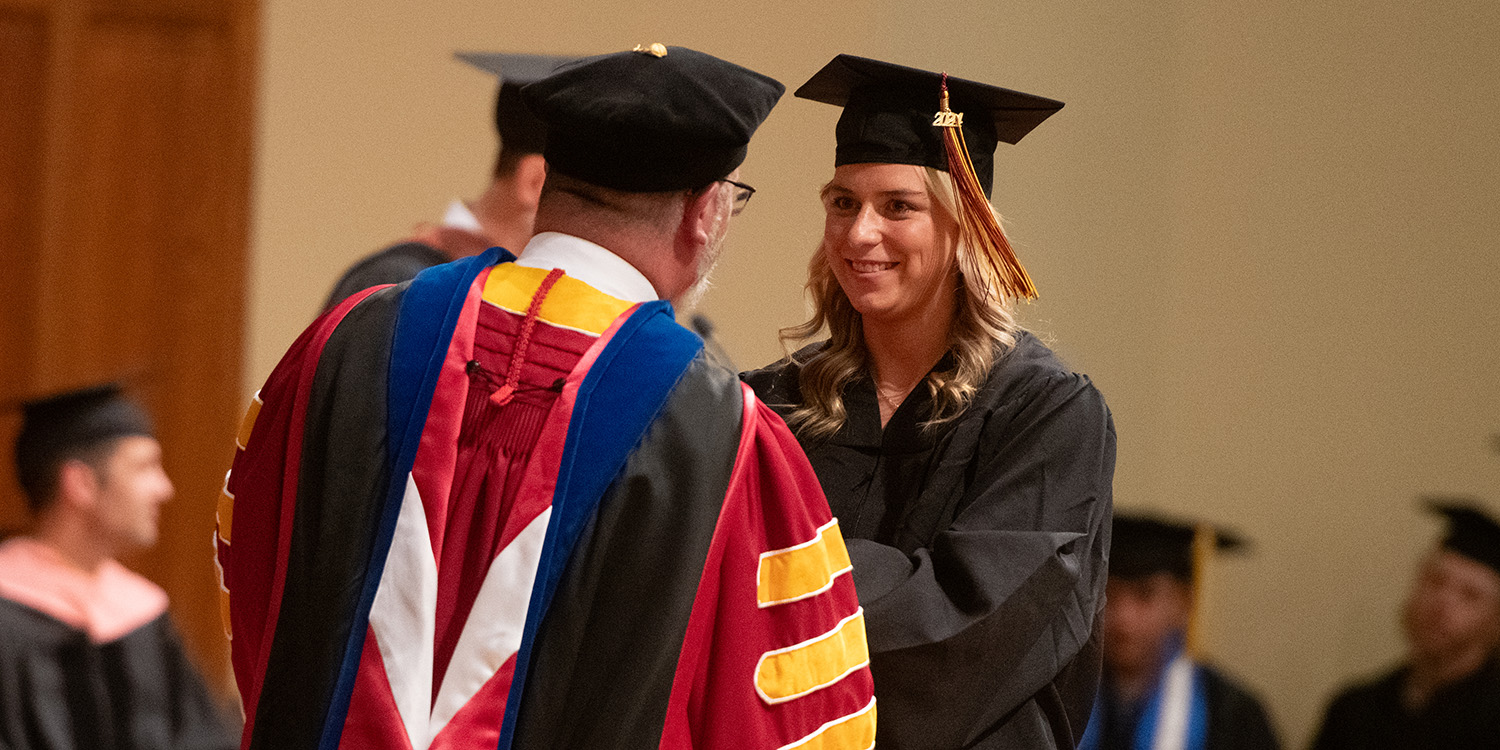 Student receiving diploma at graduation.