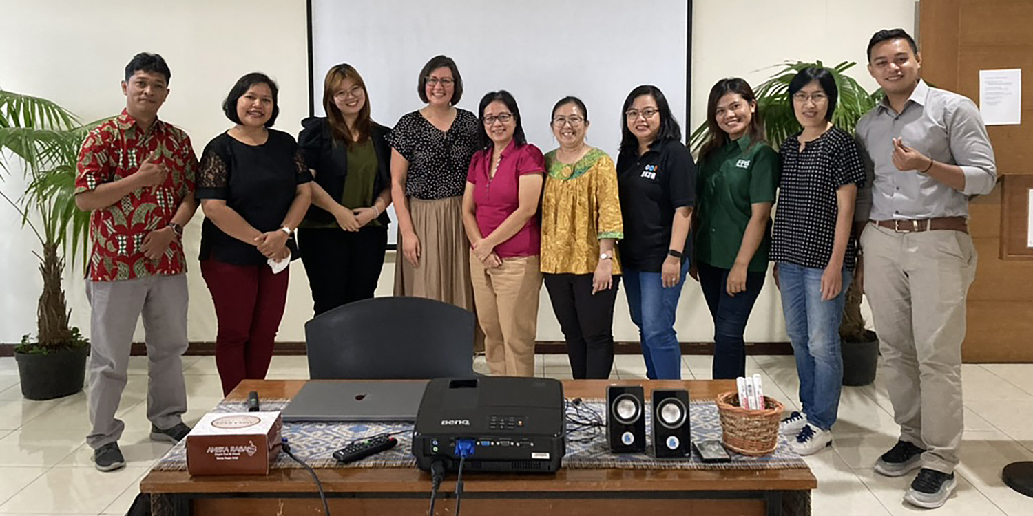 Students and professor pose in group photo.