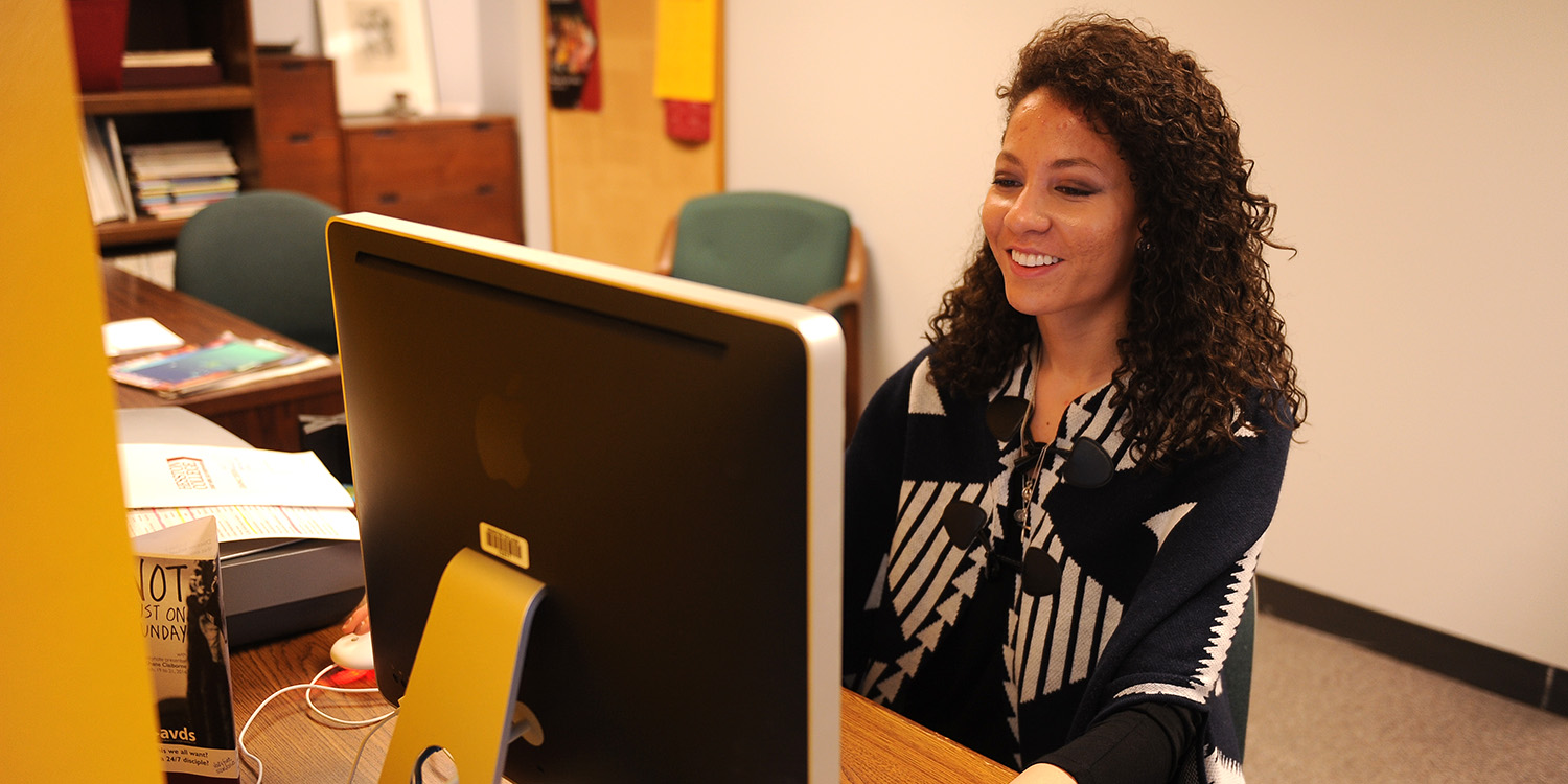 photo - Karli Rodriguez working in the Hesston College marketing and communications office