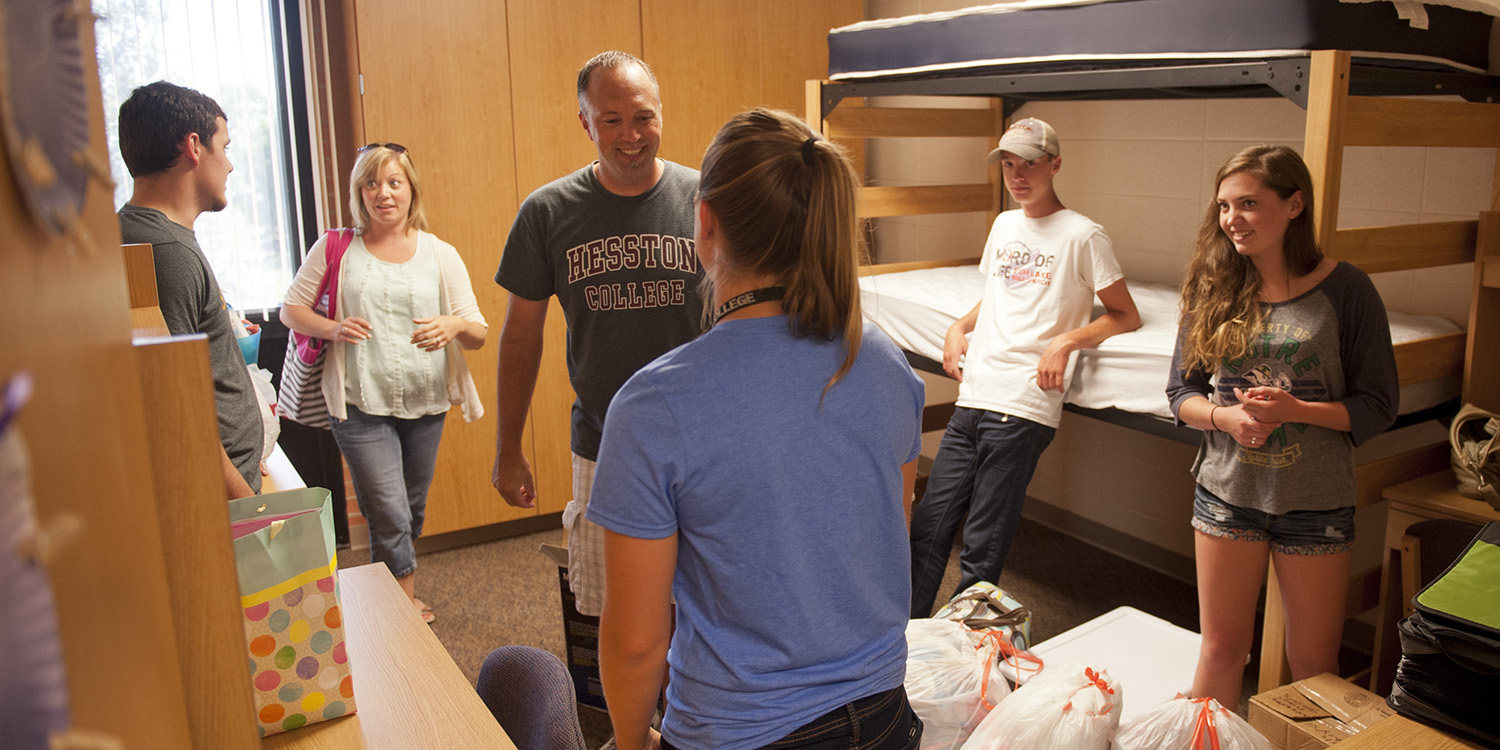 photo - Freshman Emily Weaver (White Pigeon, Mich.) (right) and her family are greeted by a resident assistant during Friday afternoon move in.