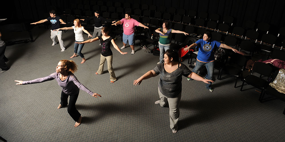 photo - Hesston College Music Theatre Workshop students work with Danika Bielik (front), dance instructor at Bethel College Academy of Performing Arts (Newton, Kan.) on choreography for their upcoming performance.