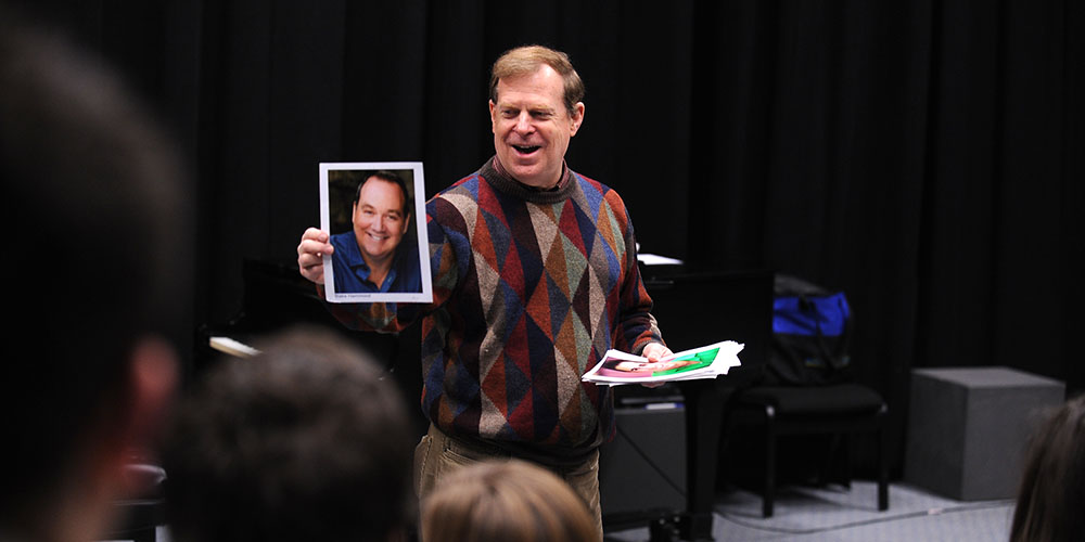 photo - Wayne Bryan, producing artistic director of Music Theatre of Wichita, shares tips about headshots with students in Hesston College’s Music Theatre Workshop class Feb. 9. Bryan was the guest presenter in the Music Theatre Workshop class and Voice Masterclass. He offered audition tips and went through mock auditions with students in the Music Theatre Workshop class and offered critiques for students singing during Voice Masterclass. Music Theatre Workshop students will showcase their work and talent with a performance at 7:30 p.m. March 1 in Northlawn 109. The performance is free and open to the public.