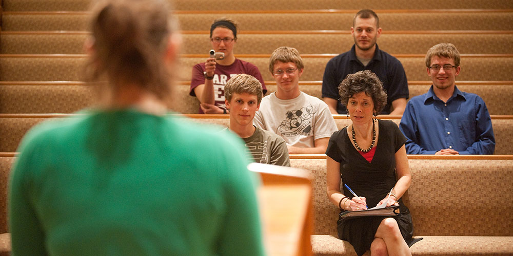 photo - Michele Hershberger and preaching class students listen as a student practice preaches.