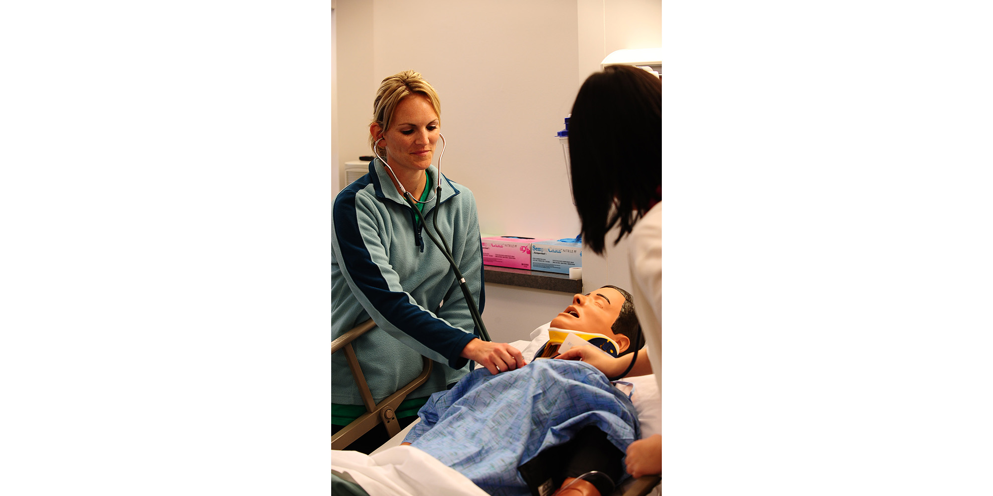 photo - Hesston College nursing students work with a patient in the college’s nursing simulation lab