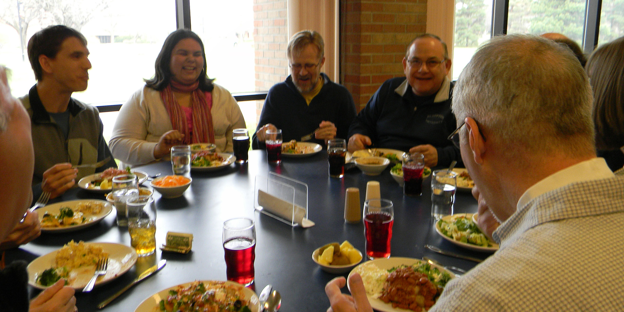photo - Campus pastors Todd Lehman (Hesston College), Joanne Gallardo (Eastern Mennonite University), Ed Janzen (Conrad Grebel University College) and Stephen “Tig” Intagliata (Bluffton University) enjoy conversation over lunch on the Hesston College campus March 29. The campus pastors from the Mennonite colleges and universities meet annually to network and fellowship with one another.