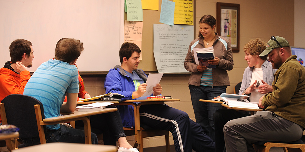 photo - A group of Hesston College students discusses concepts in their Positive Psychology class.