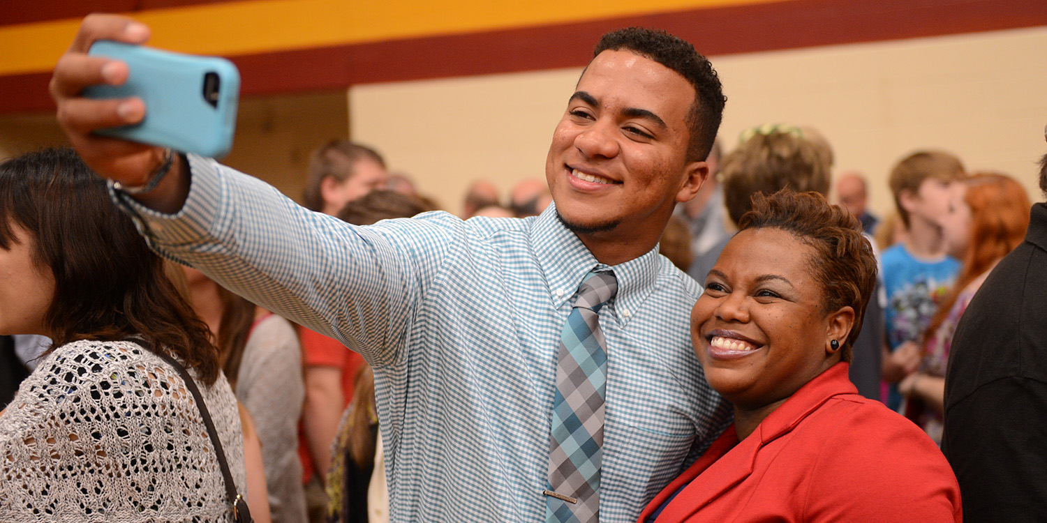 photo - Graduate Lucas Garces Soliman (Santo Domino, Domincan Republic) takes a post-graduation selfie with biology instructor Marelby Mosquera.