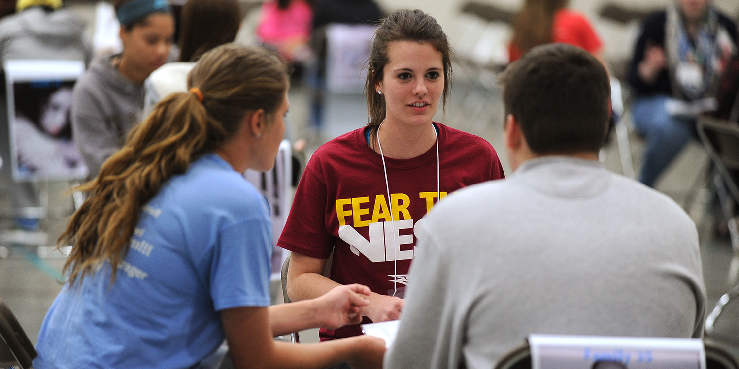photo - Freshman Vanessa Steckly (Milford, Neb.) makes plans with her family group at the start of the poverty simulation.
