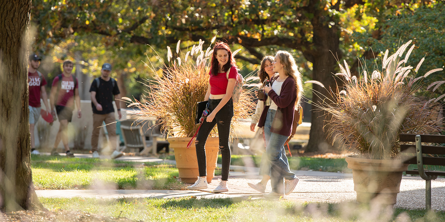Three students walking through campus.