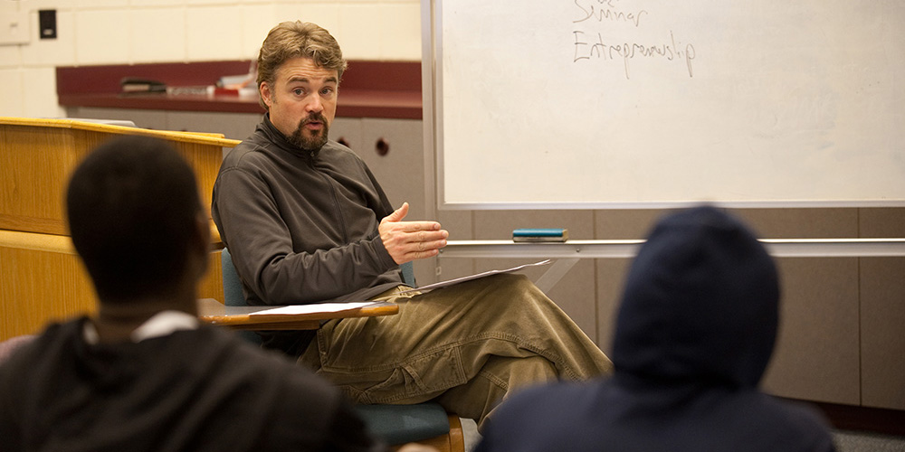 photo - David LeVan talks with a group of his first-year advisees about planning their courses.