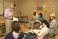 Hesston College professor Al Yoder explains a point during an ESL (English as a Second Language) course during the spring semester. Yoder is retiring from the college at the end of the present school year in early May.