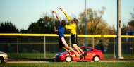 Hesston College sophomore Kyle Vogt, Harper, Kan., makes the catch as Tabor College freshman Jacob Heil, Wichita, Kan., defends.