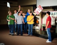 Jesus, played by Omar Reyes (right) tests his followers’ willingness to “Follow me,” in a sketch from the original play “This is Your Pig.” Performers from left are Cody Zabroski, Jeron Baker, Rachel Brown, Ryan Kopper, Leah Baker, Anna Yoder and Margaret Wiebe.