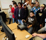 Marshall Middle School sixth graders watch a classmate fly the flight simulator as part of their Hesston College fieldtrip.