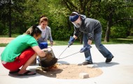 Art faculty member Hanna Eastin (right) assists students with a raku firing.