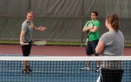 Hesston tennis coach Jeron Baker works with players