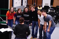 Cast members rehearse a scene from Hesston College's spring musical.