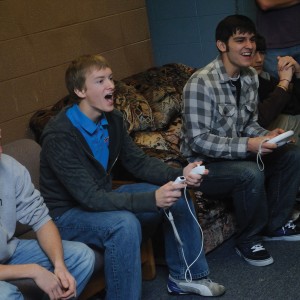 From left, freshman Kenny Graber of Stryker, Ohio, Bradley Sandlin of Valley Center, Kan., Stephen Quenzer of Visalia, Calif., and Harrison Beachey of New Paris, Ind., play a video game in their Erb west lounge.