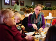 Kirsti Graffenberger (right) helps a resident with a presentation on the health benefits of rutabagas at Schowalter Villa as part of her cooperative learning experience.