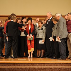 Michele Hershberger is surrounded by friends at her ordination service
