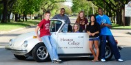 Hesston College students with the college's VW Super Beetle